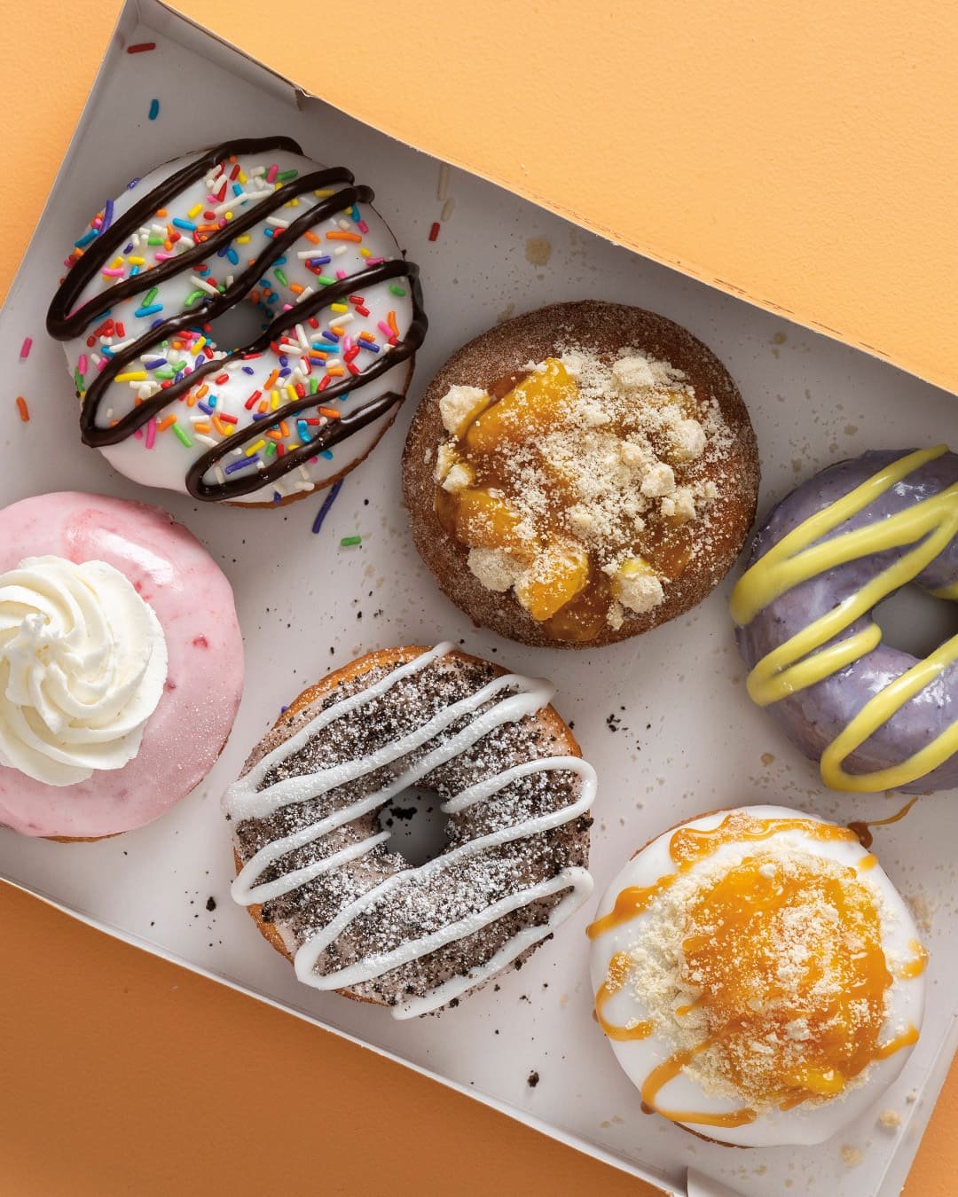 Ice cream served with donuts and desserts for breakfast catering at Duck Donuts, including vegetarian options.